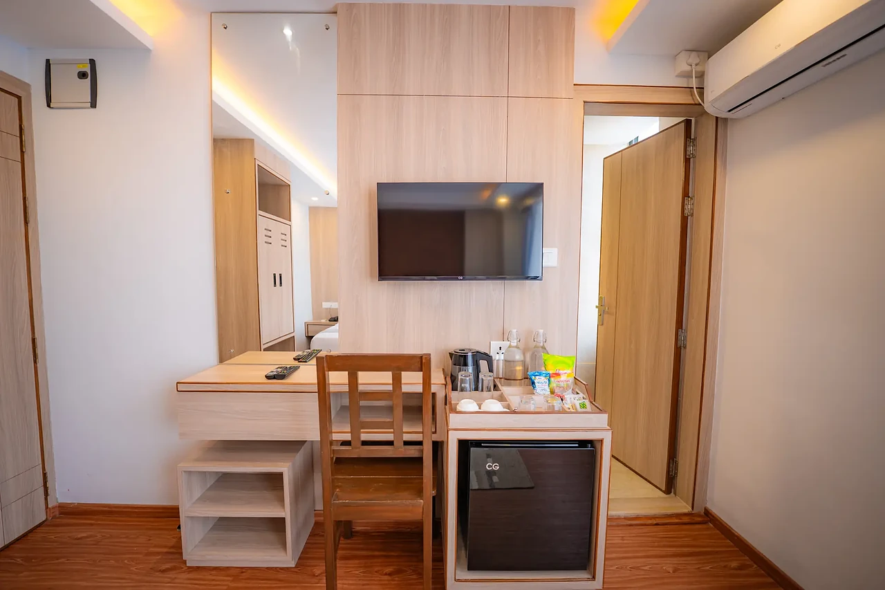 Deluxe Room workspace with smart TV and minibar