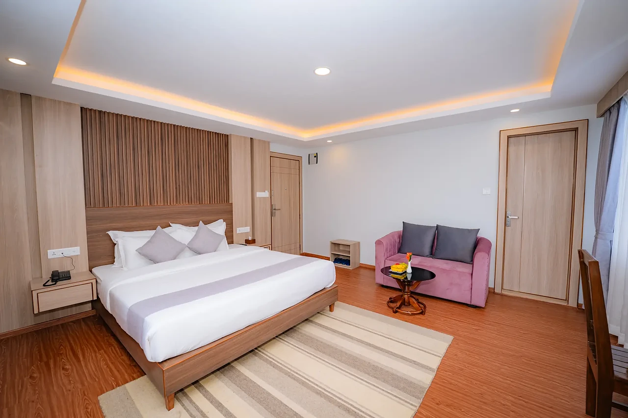 Hotel Sampada suite with king bed and sitting nook