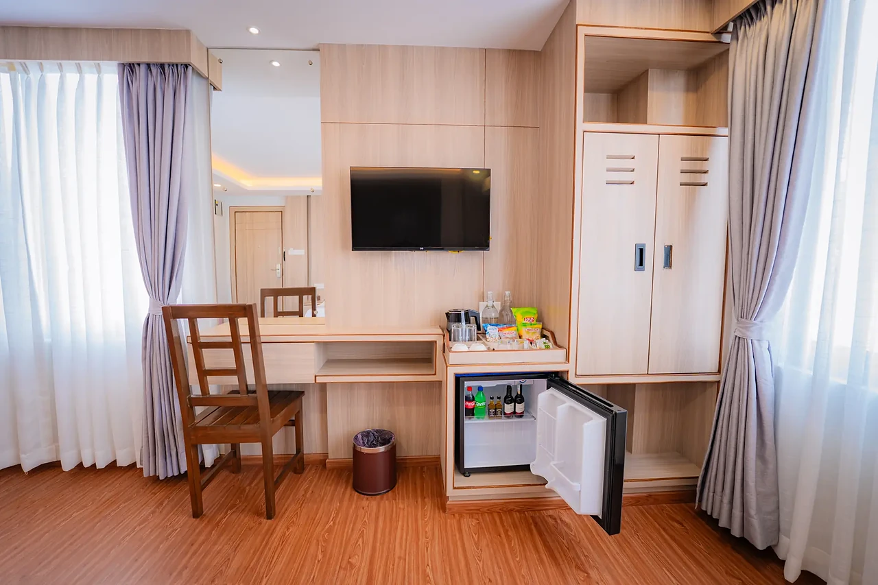 Suite work desk, smart TV and minibar at Hotel Sampada