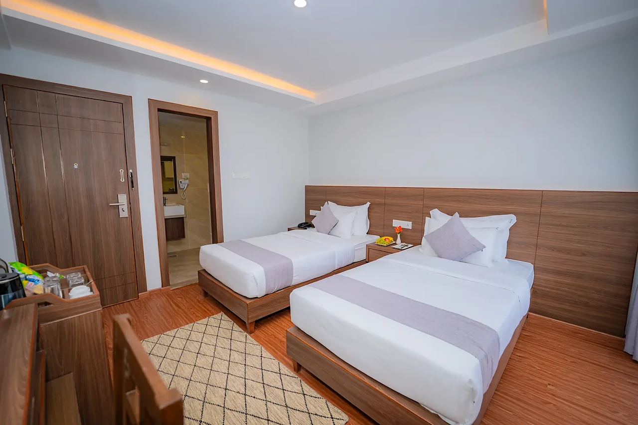 Premium Room with a double and a single bed at Hotel Sampada