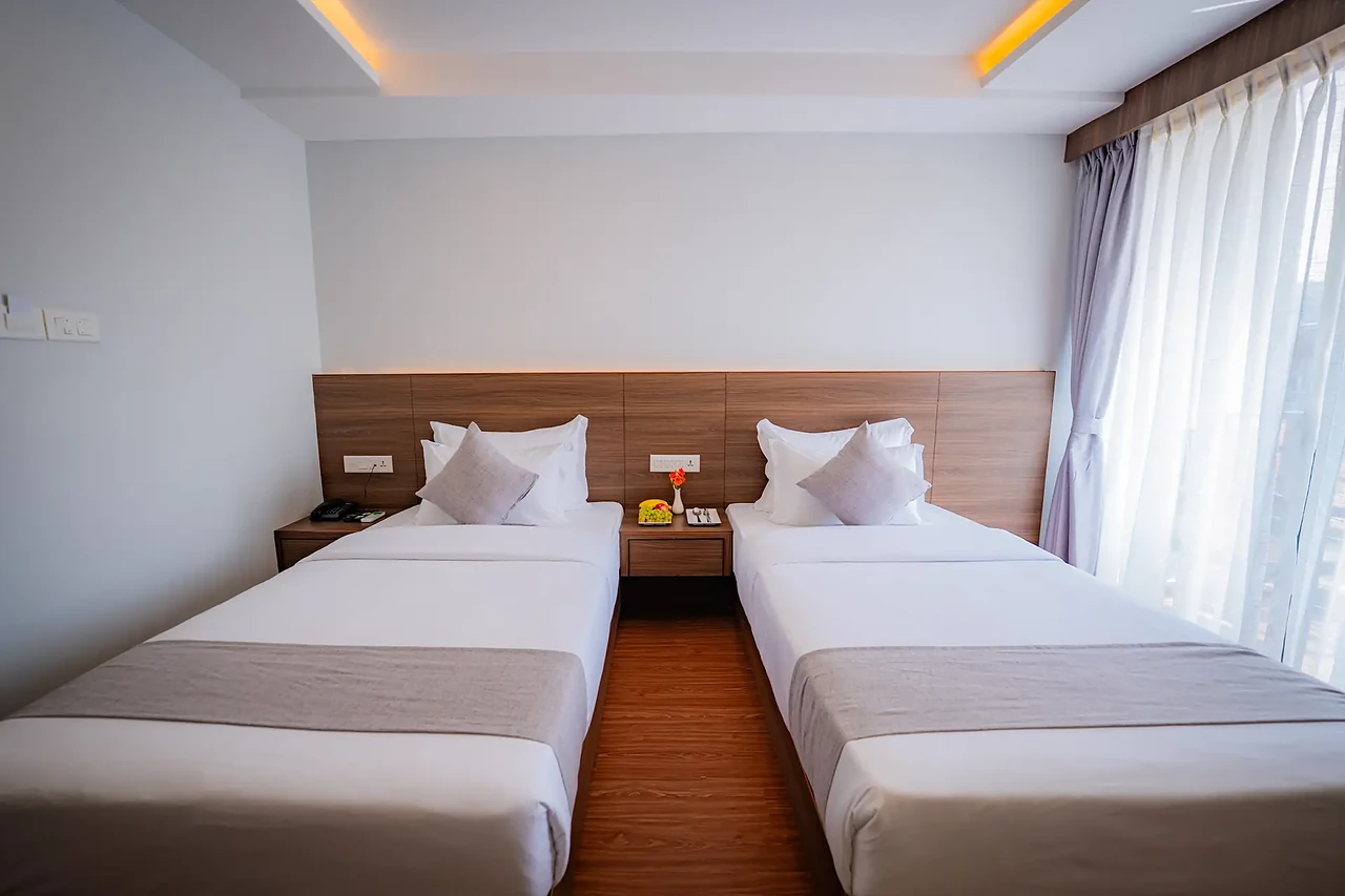 Twin beds in a Hotel Sampada Premium Room