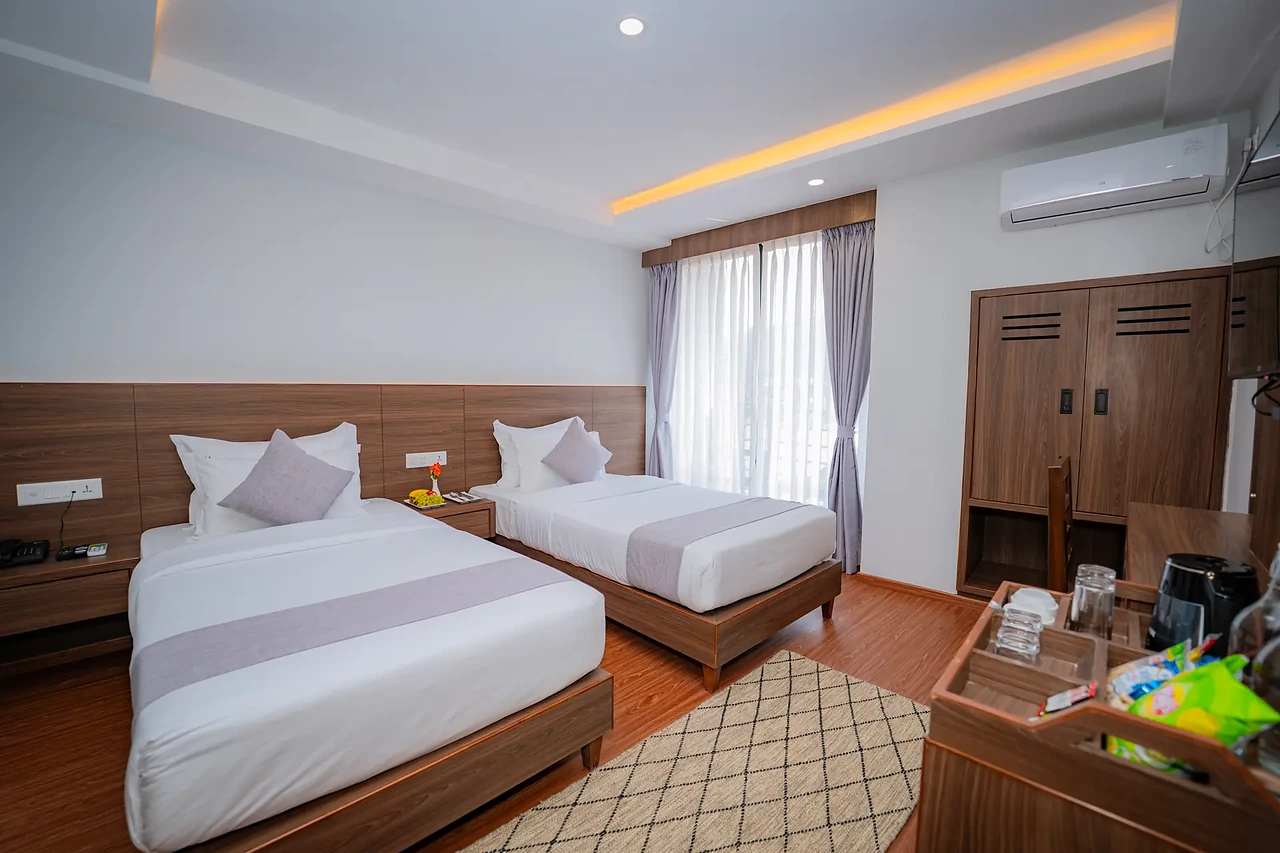Premium Room with two beds and a window at Hotel Sampada